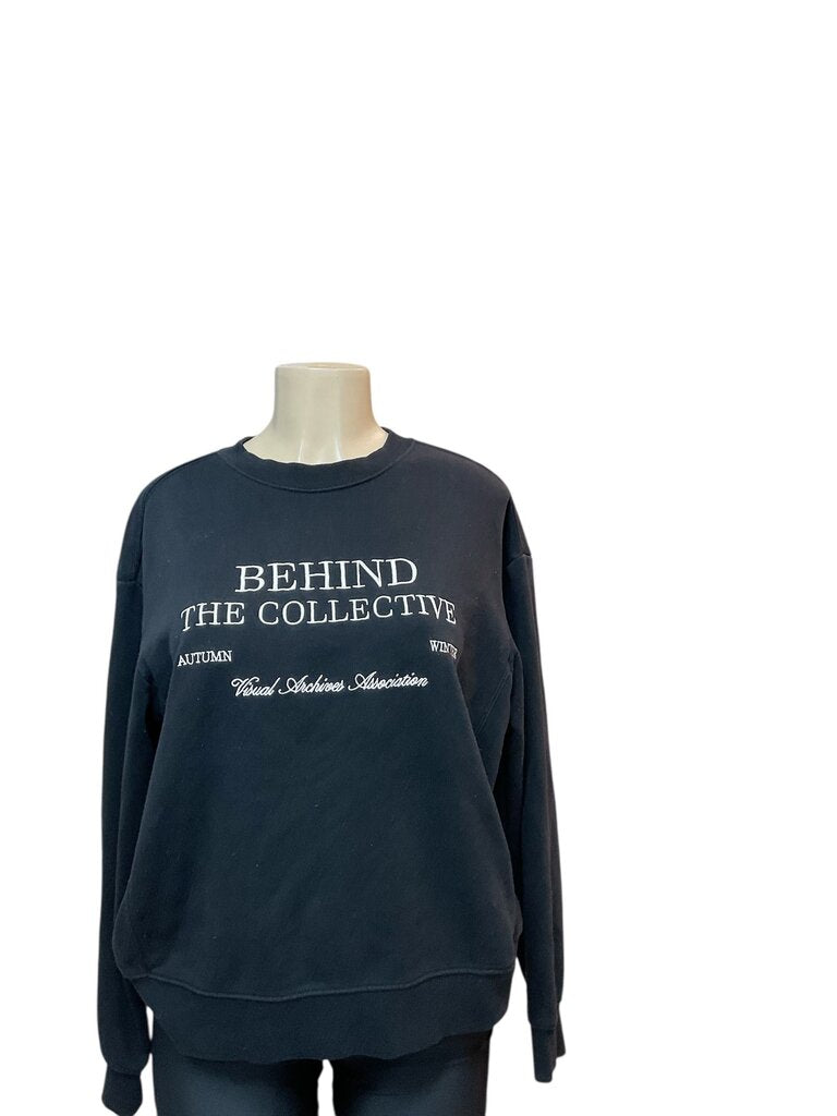 Behind the collective black Crewneck sweatshirt