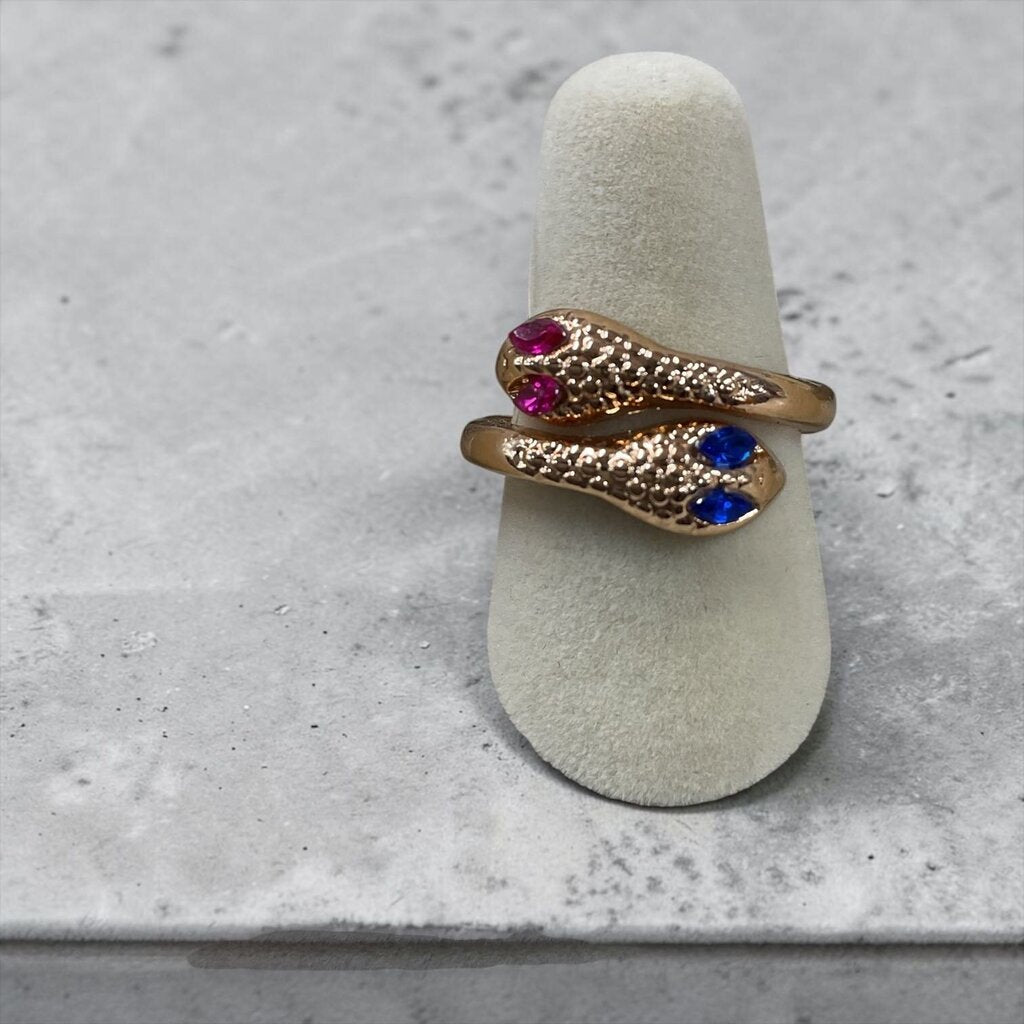 Gold Snake Ring feat textured detailing sapphire eyes and vibrant ruby accent